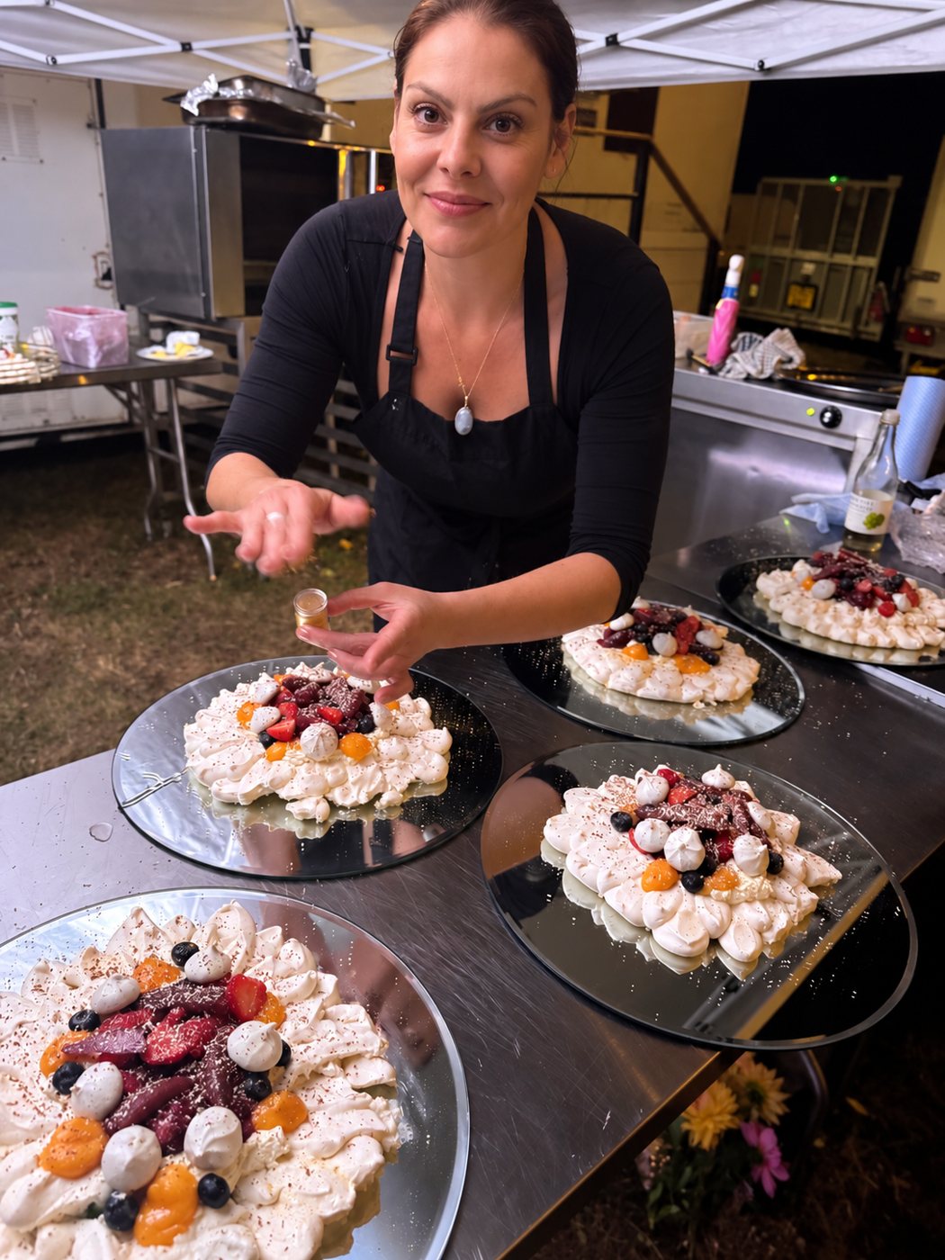 A House of Vida chef plating desserts beside the catering truck
